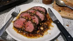 Peppercorn-crusted beef tenderloin with garlic brown-butter sauce (perfectly pink)
